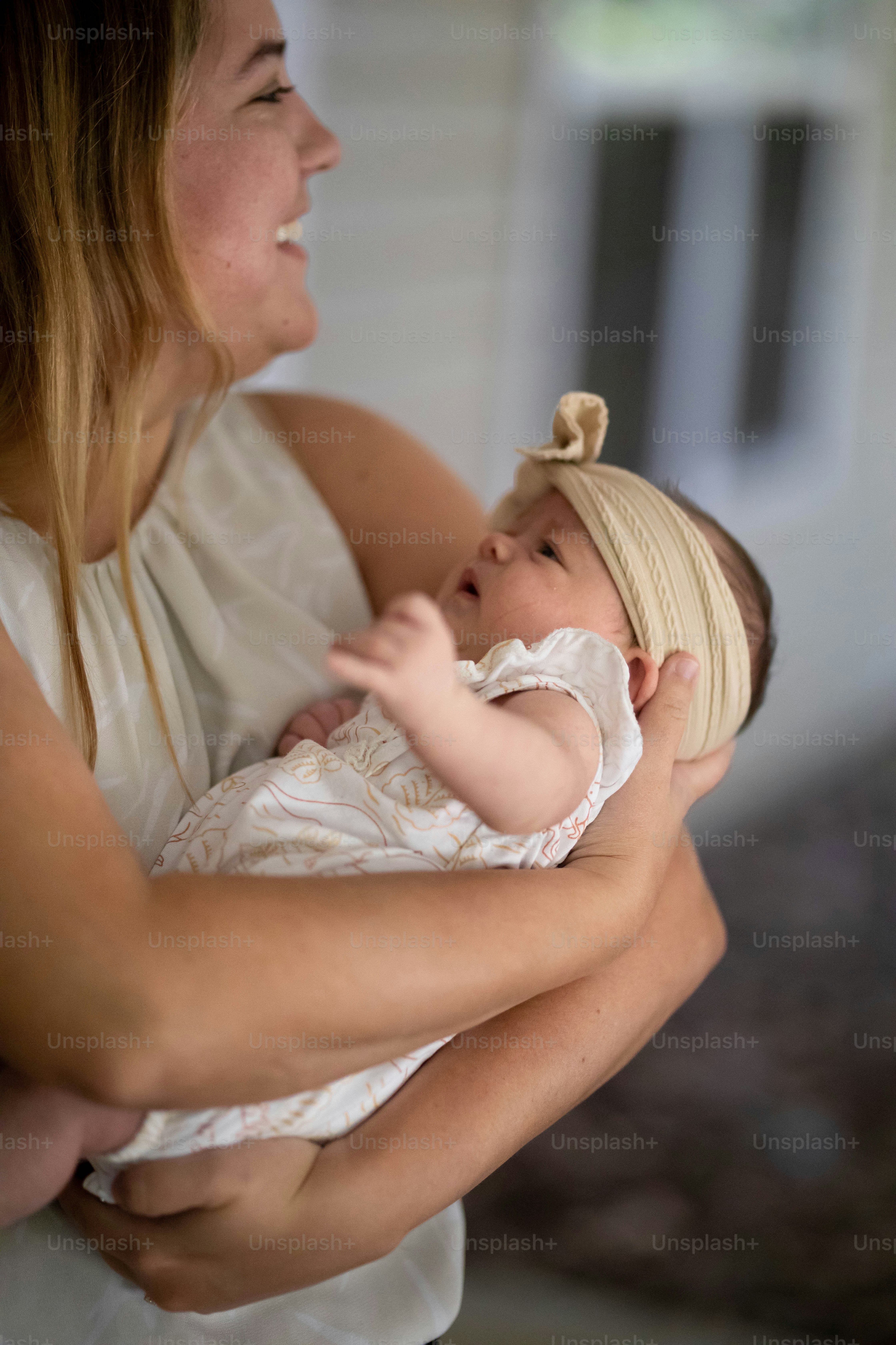a woman holding a baby in her arms