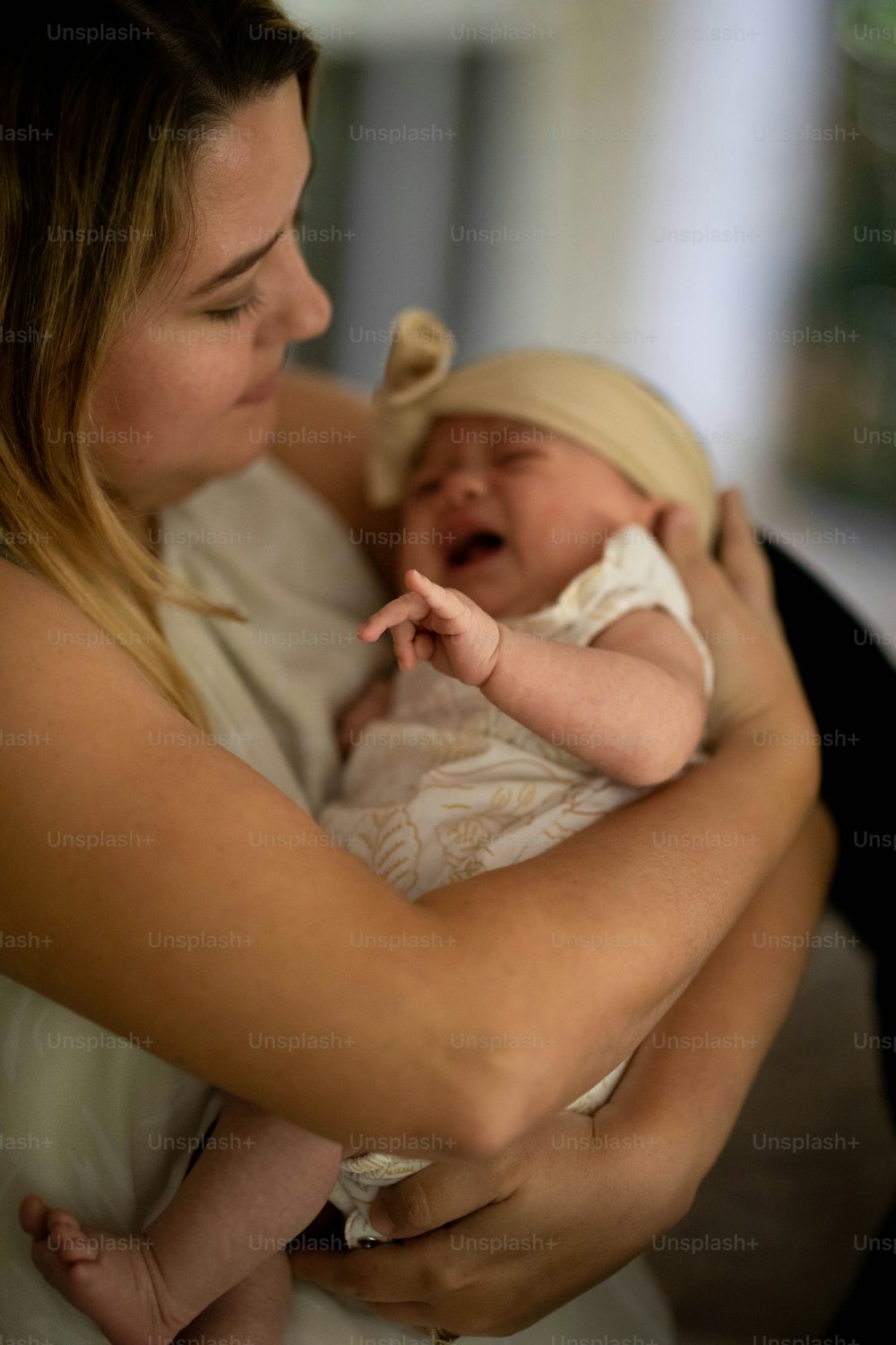 a woman holding a baby in her arms