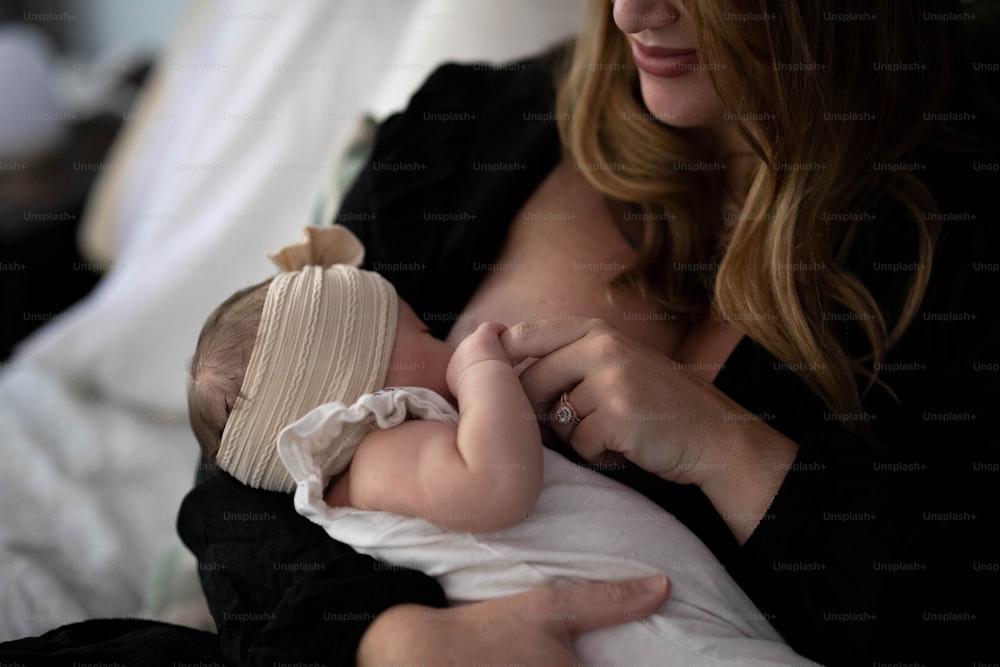 a woman holding a baby in her arms