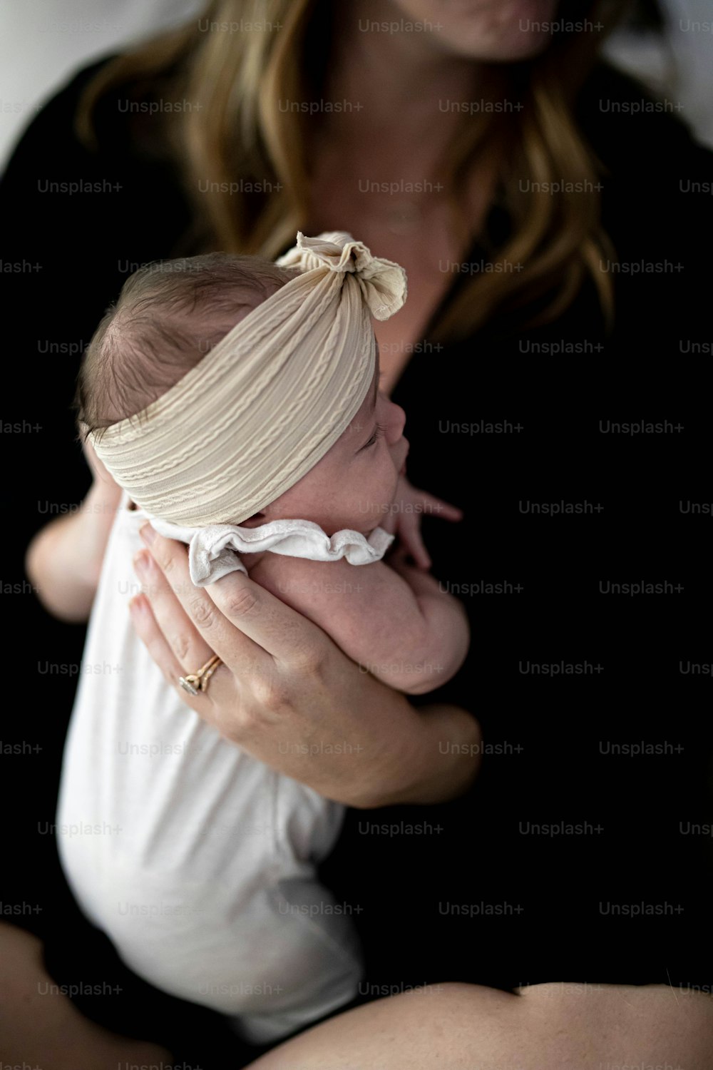 a woman holding a baby in her arms