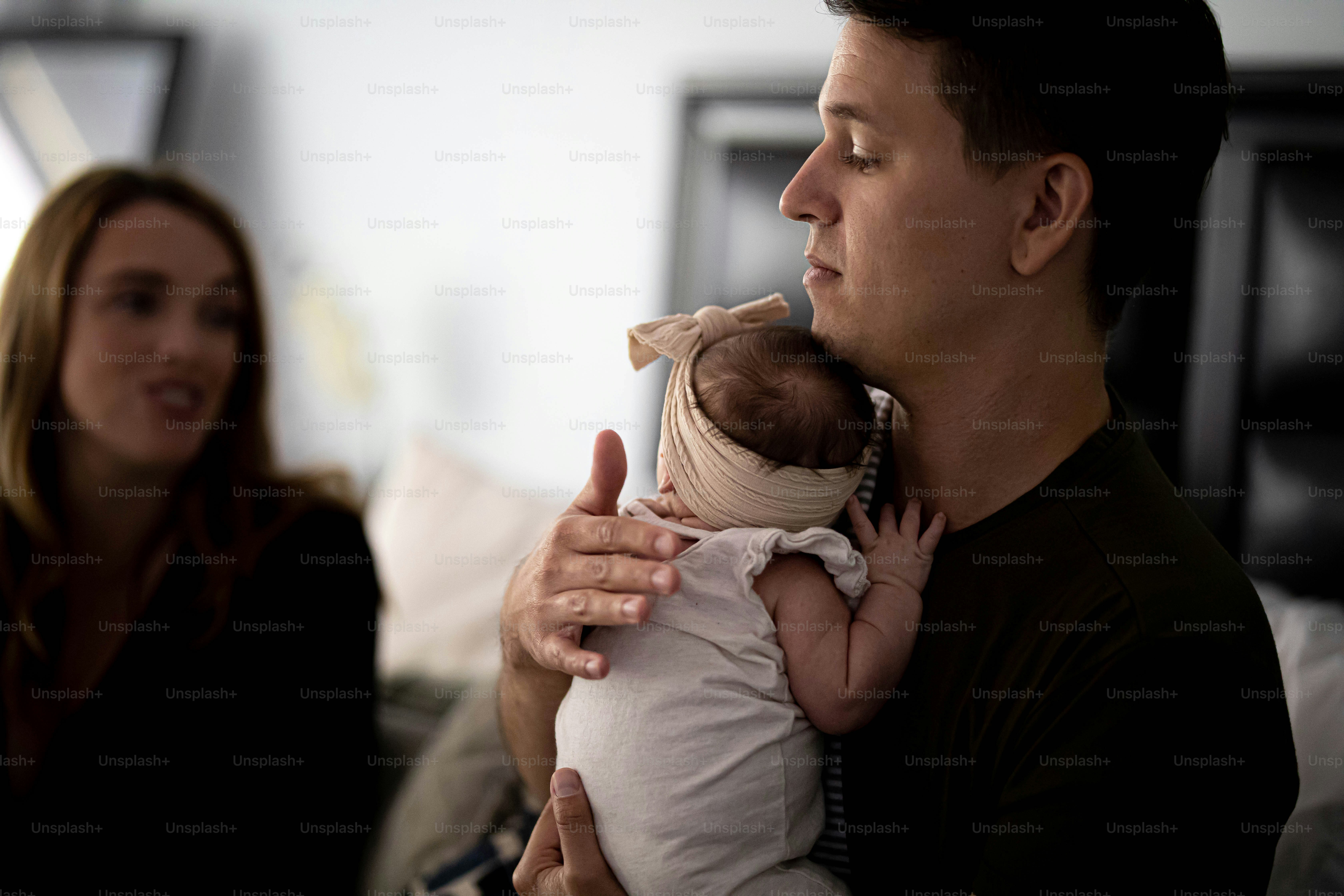 a man holding a baby in his arms