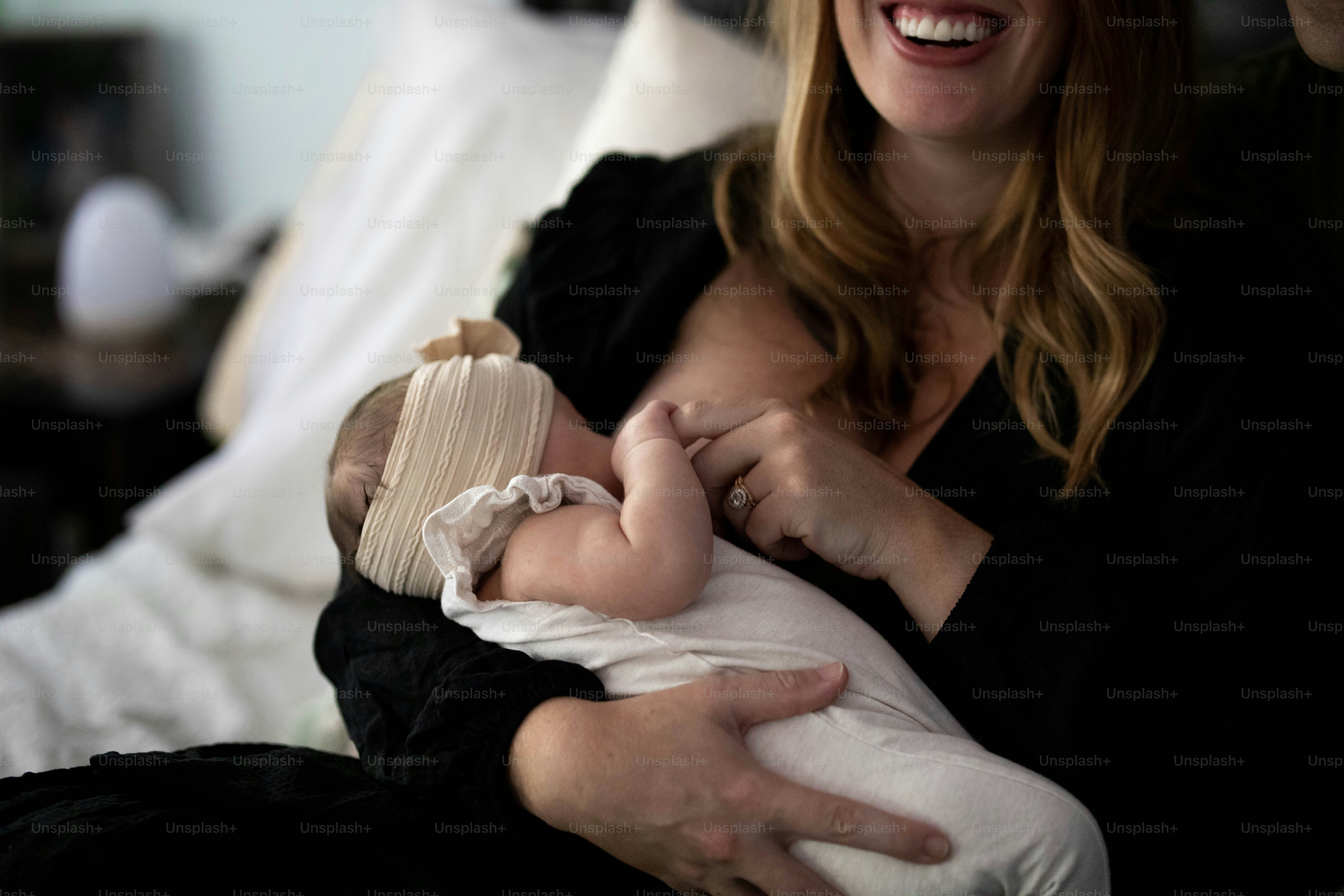 a woman holding a baby in her arms