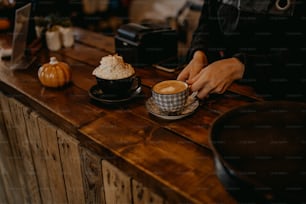 a person sitting at a counter with a cup of coffee