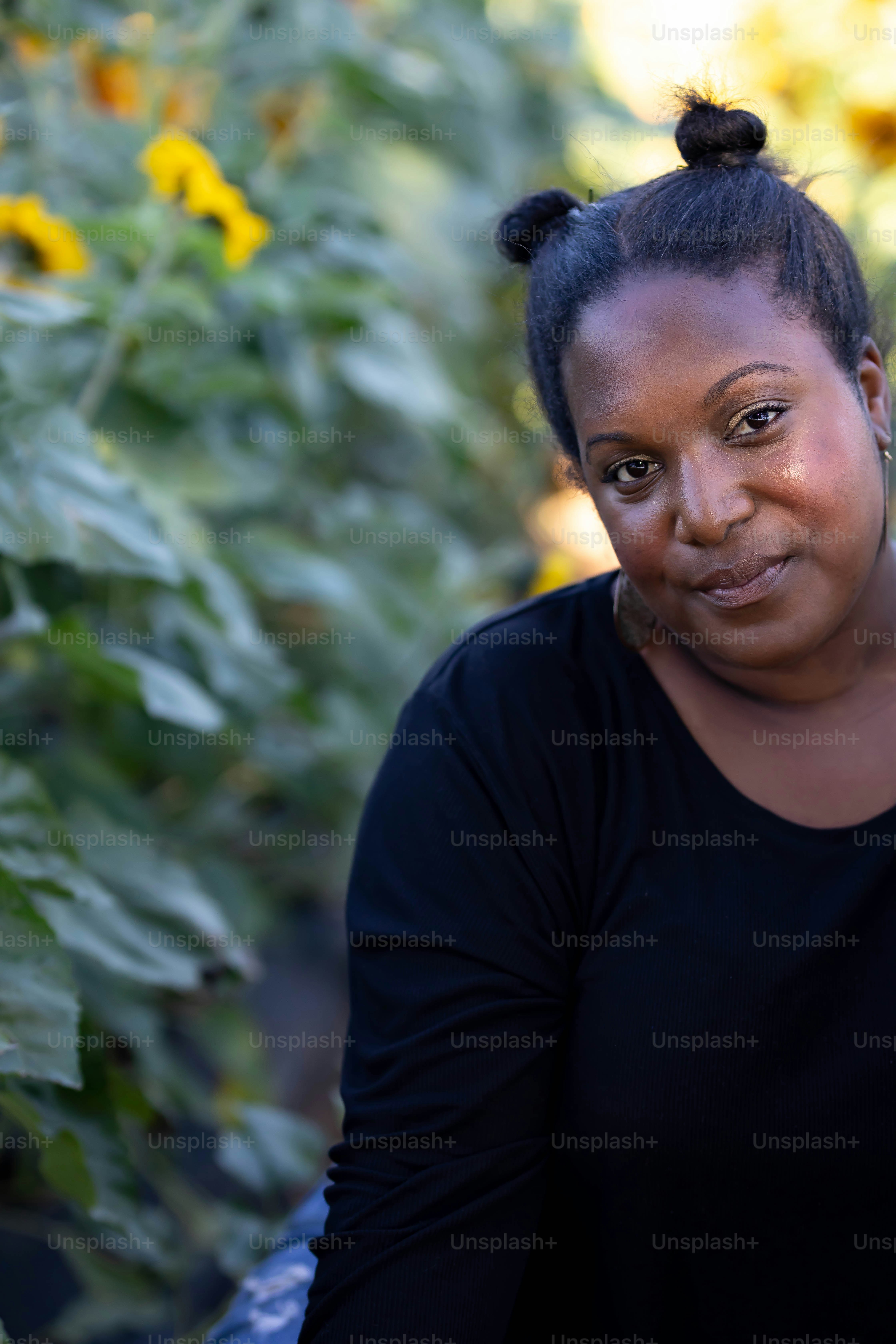 A woman standing in front of a field of sunflowers photo – Shadows ...