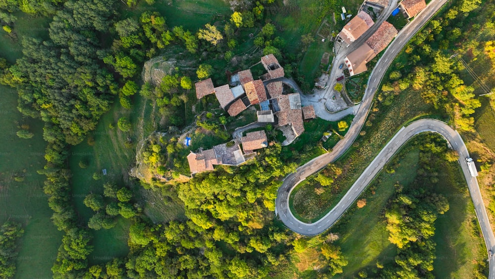 an aerial view of a house in the middle of a forest