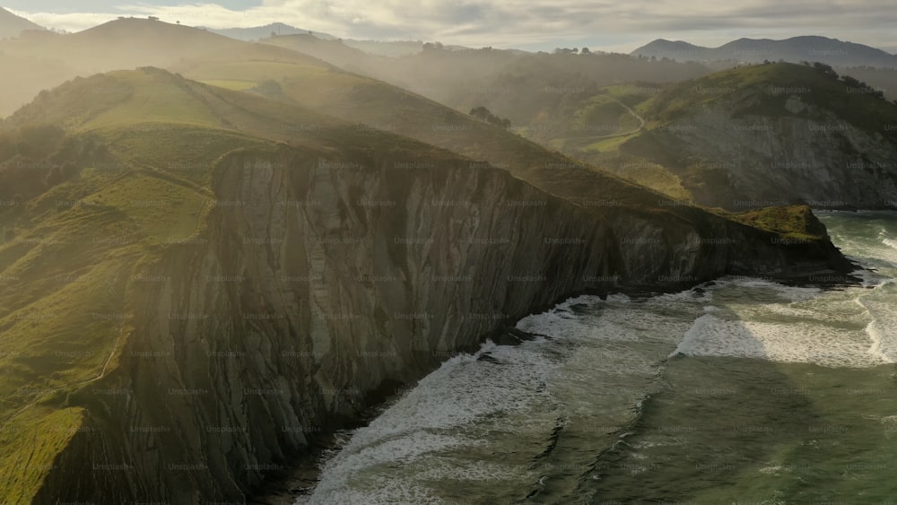 an aerial view of the ocean and mountains