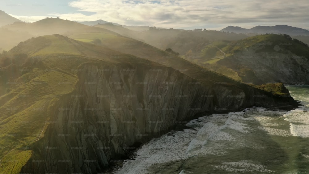 an aerial view of a mountain and a body of water