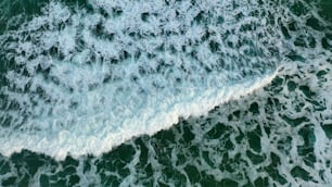 a person riding a surfboard on a wave in the ocean