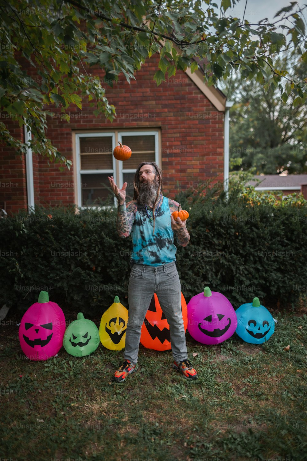 a man standing in front of a group of pumpkins