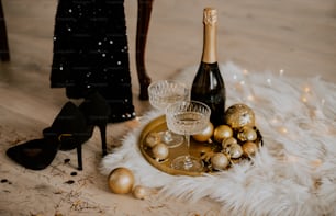 a table topped with champagne and christmas ornaments