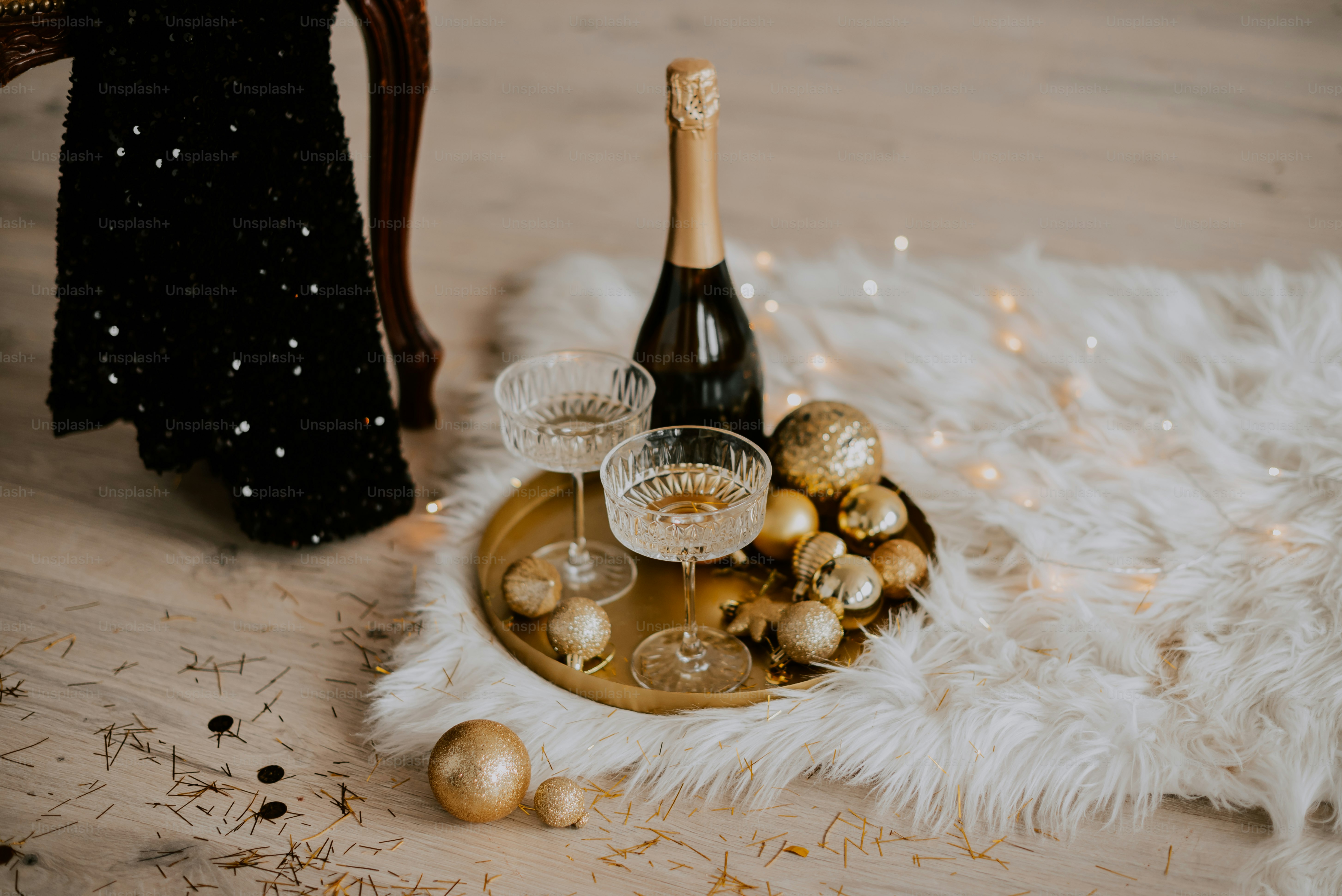 a bottle of champagne and two glasses on a tray