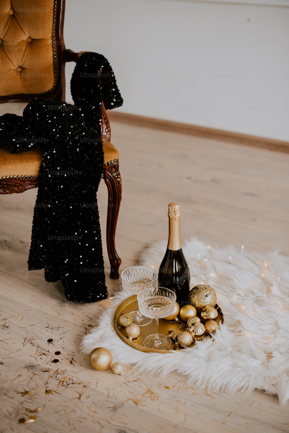 a bottle of champagne sitting on top of a wooden floor
