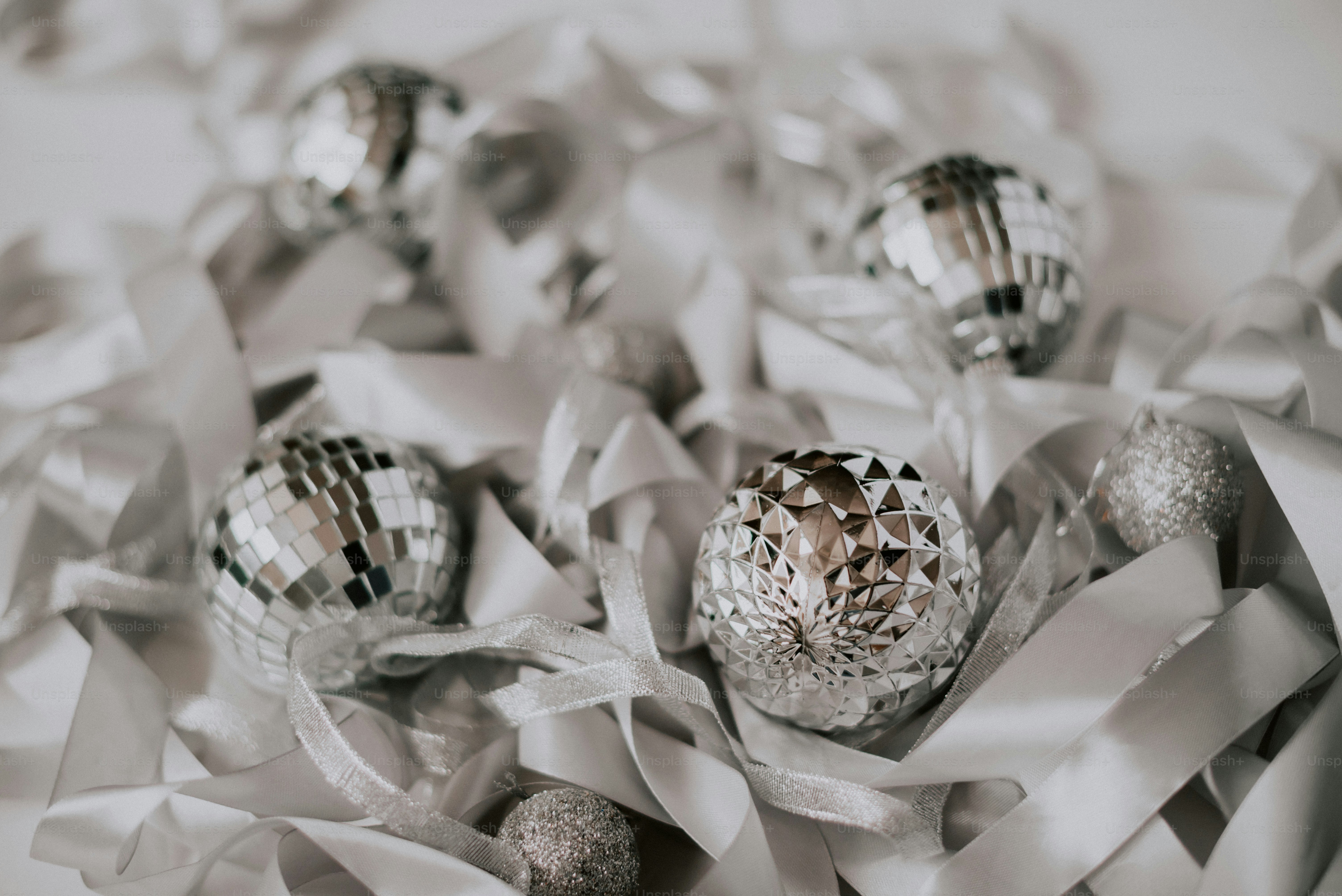 a bunch of shiny balls sitting on top of a white sheet