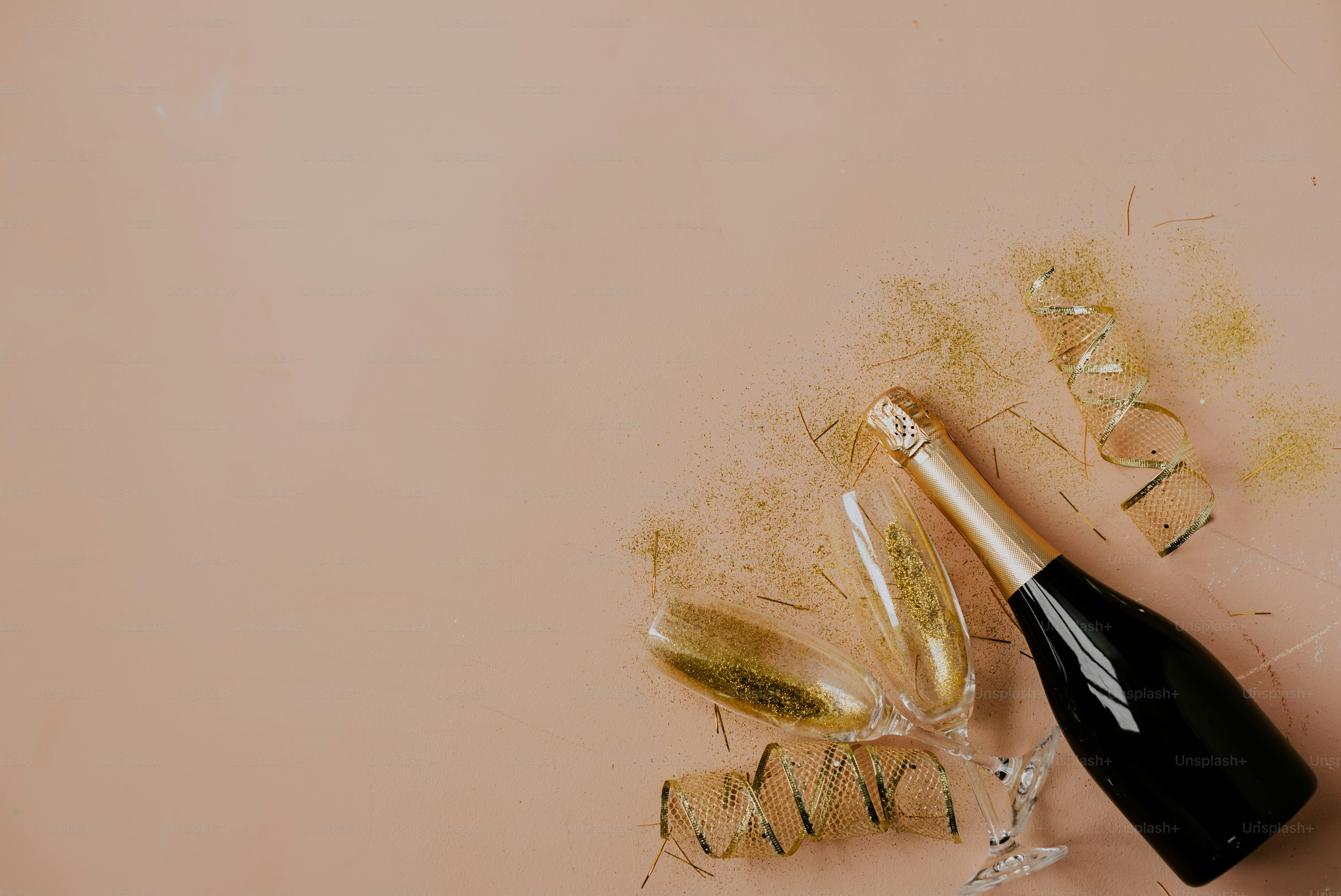 a bottle of champagne next to a broken glass