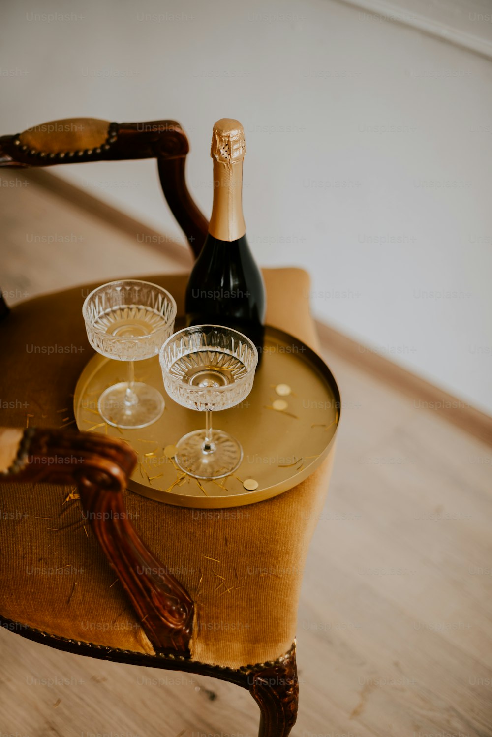 a bottle of wine sitting on top of a wooden table