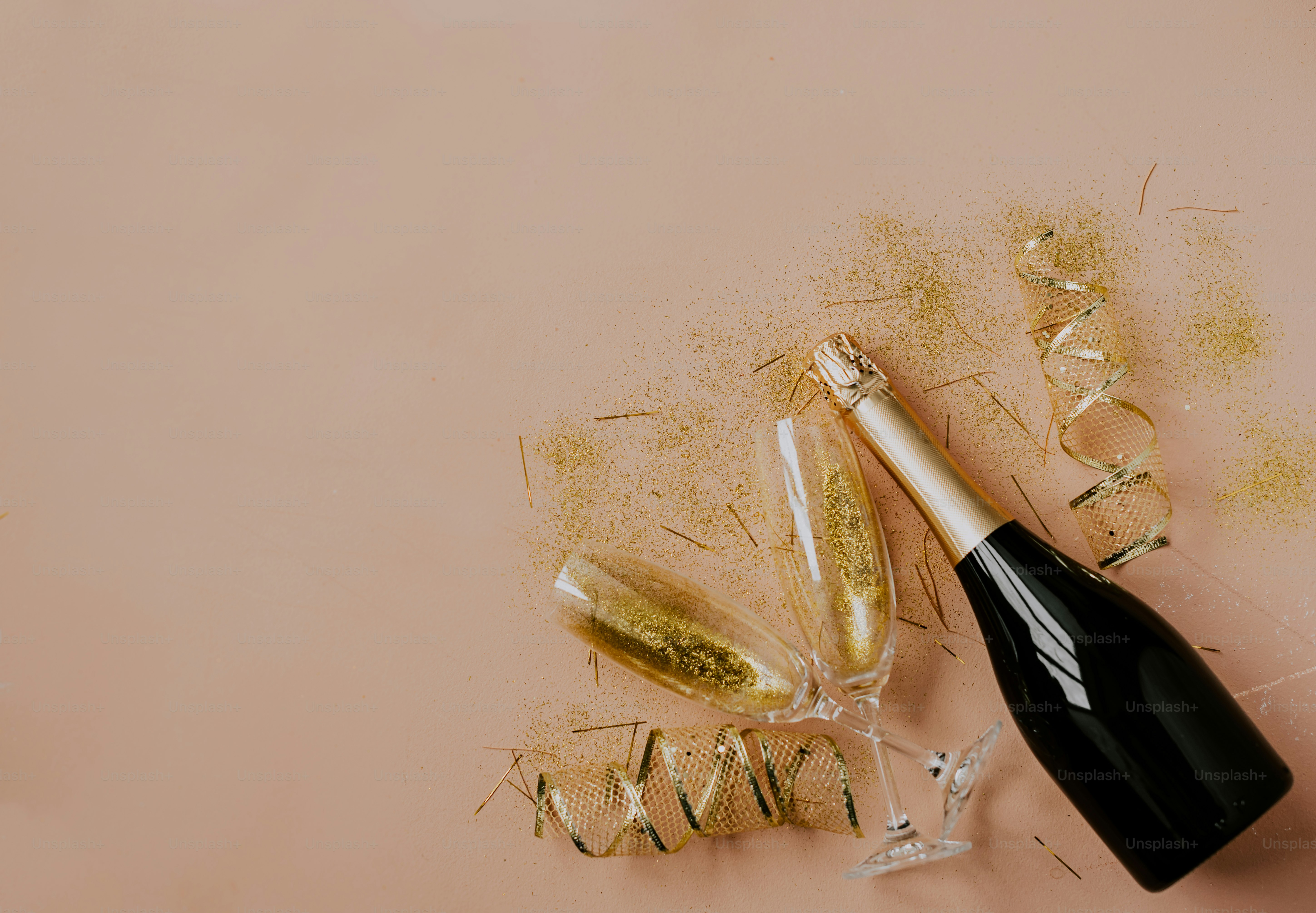 a bottle of champagne next to some gold confetti