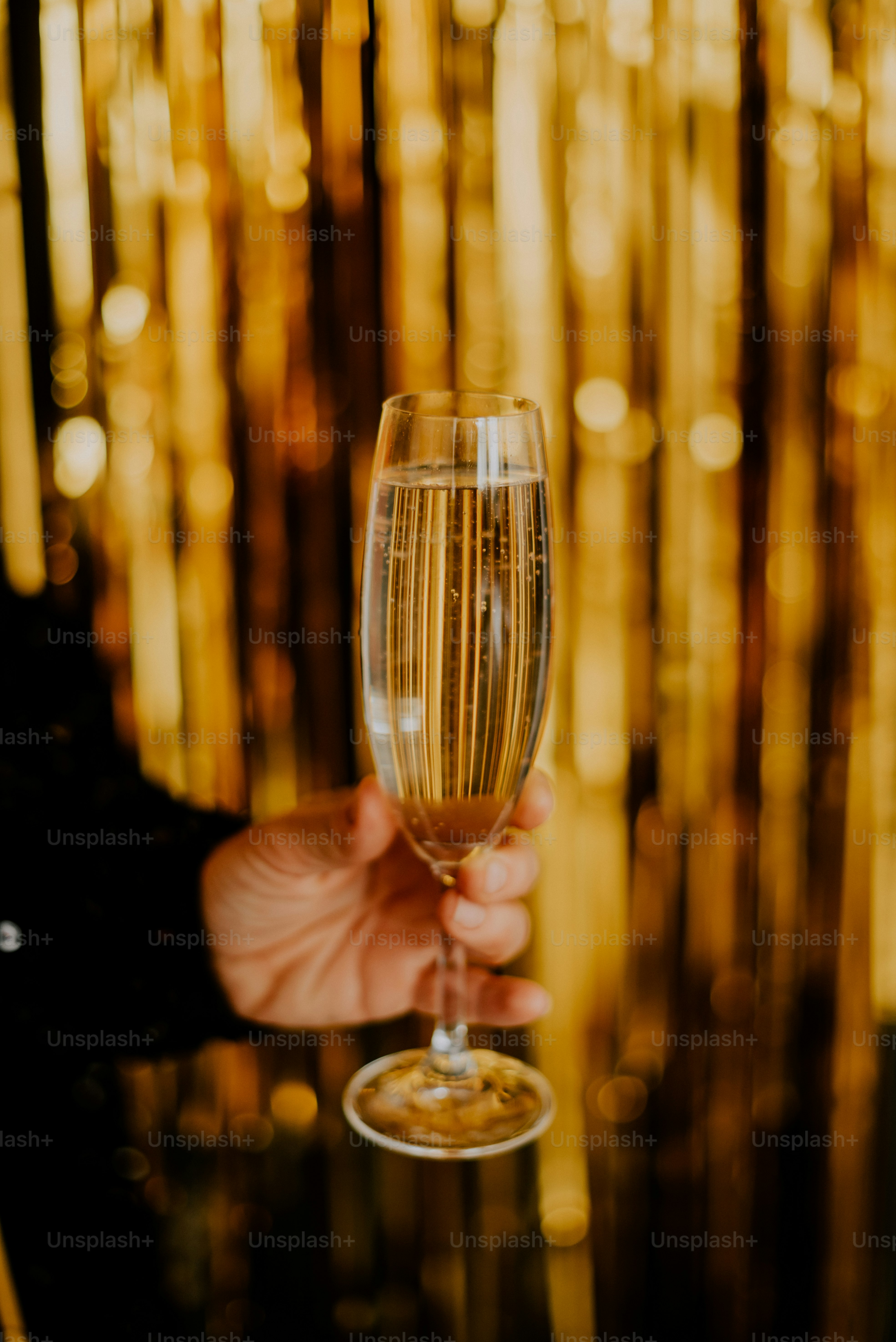 a person holding a wine glass in their hand