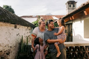 a man and two women are holding a child