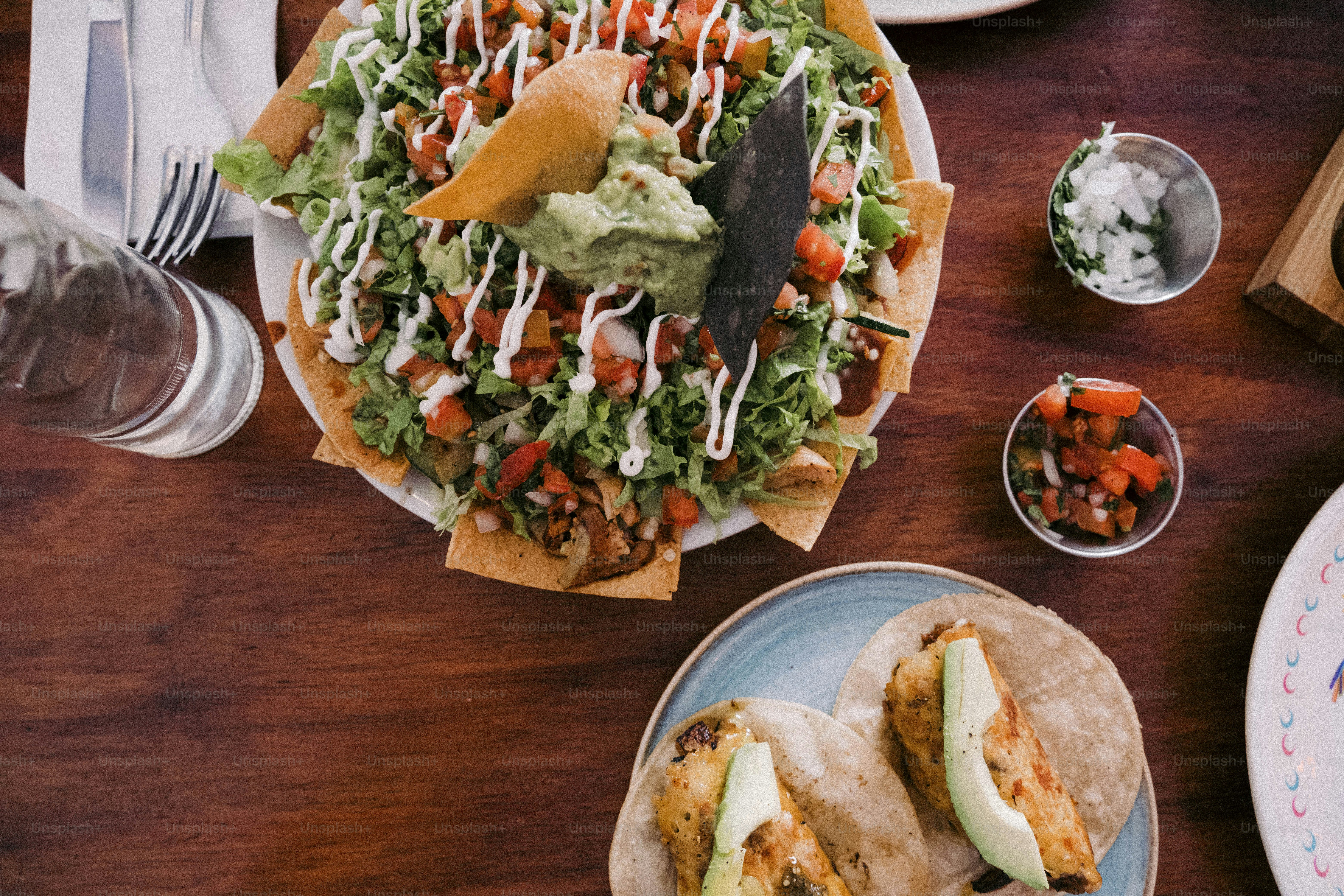 a wooden table topped with plates of food