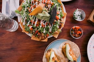 a wooden table topped with plates of food