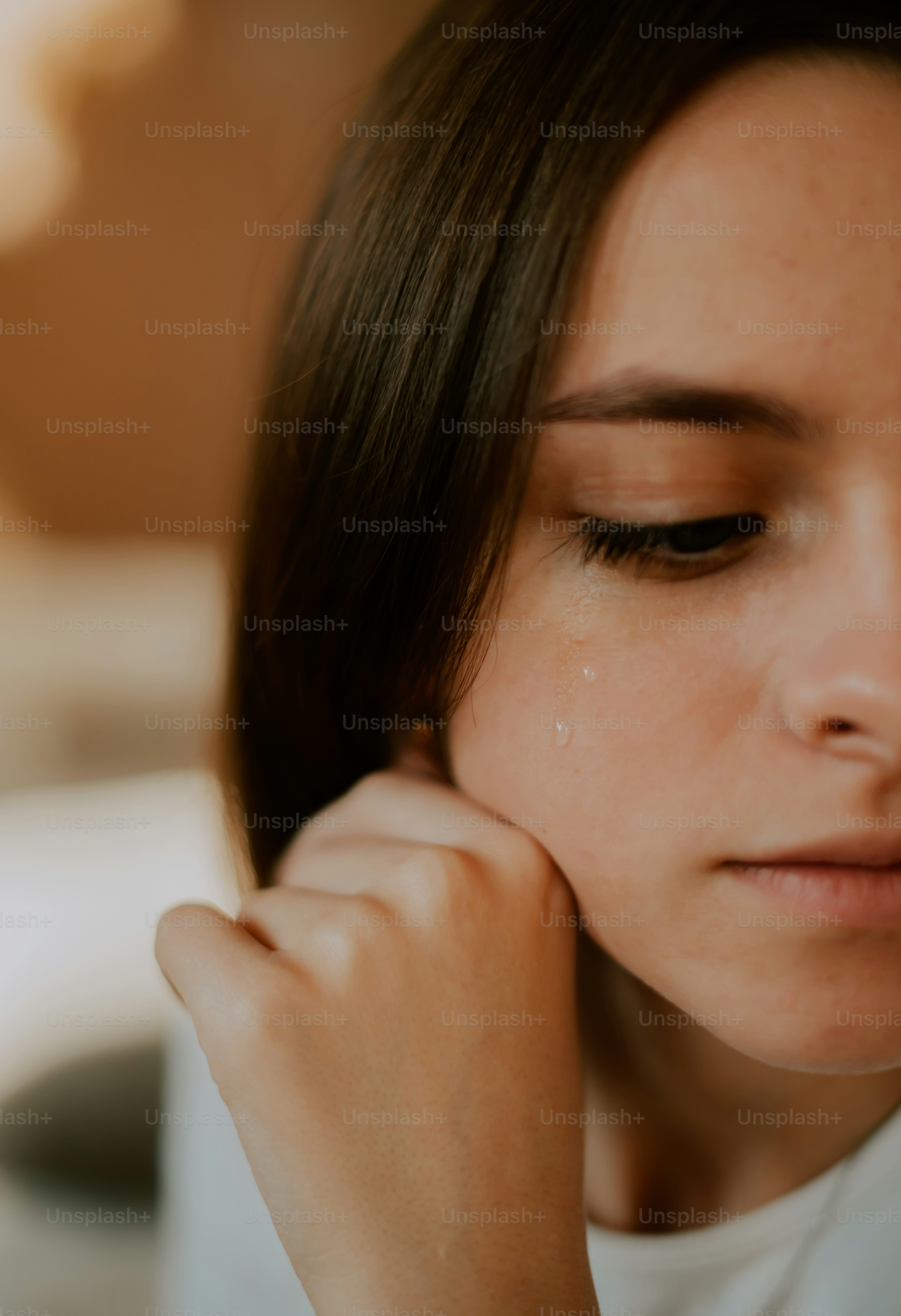 a woman holding her hand to her ear