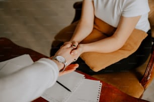 a man and a woman shaking hands over a piece of paper