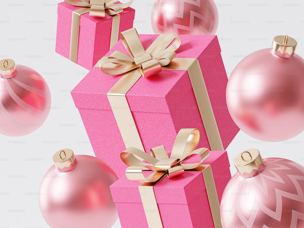 a pink gift box with gold ribbon and ornaments around it
