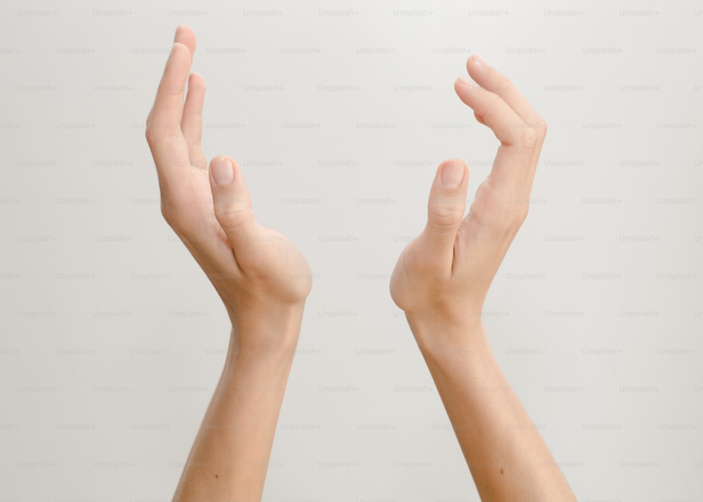 a person holding their hands up in the air