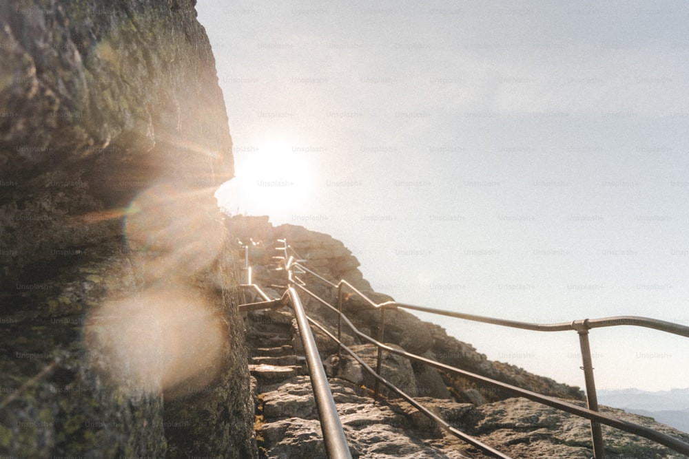 a metal hand rail going up the side of a mountain