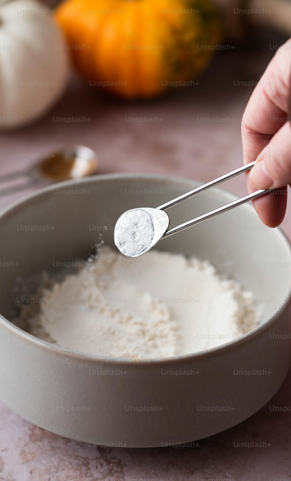 a person holding a spoon in a bowl of rice