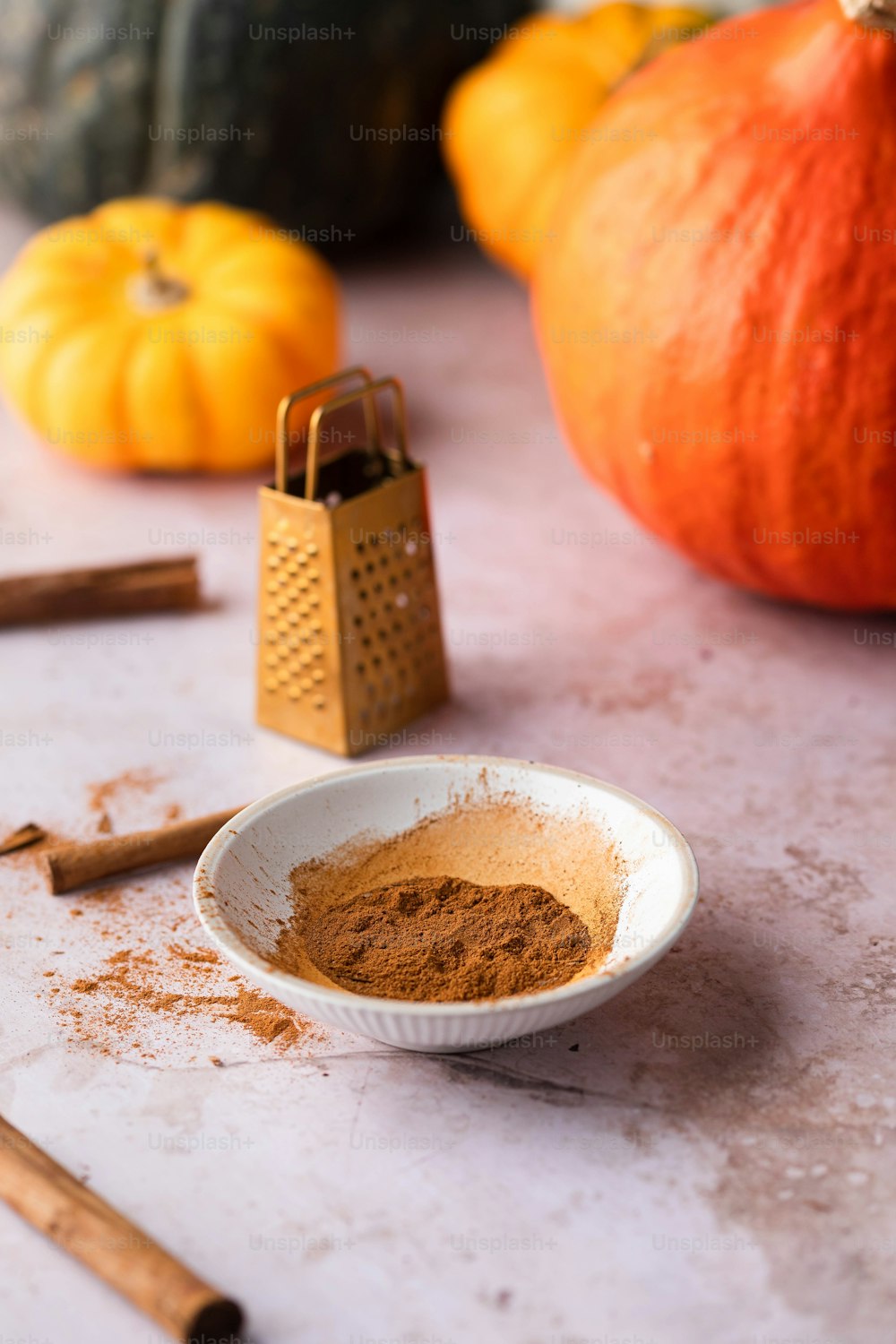 a bowl of cinnamon sits on a table