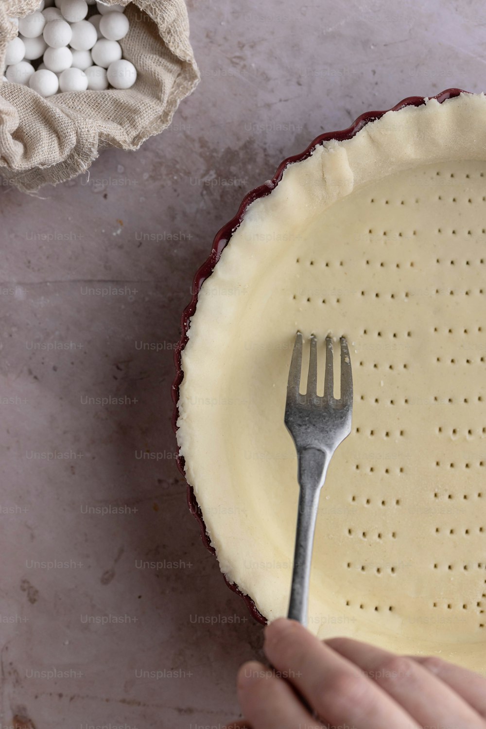 a person holding a fork over a pie crust