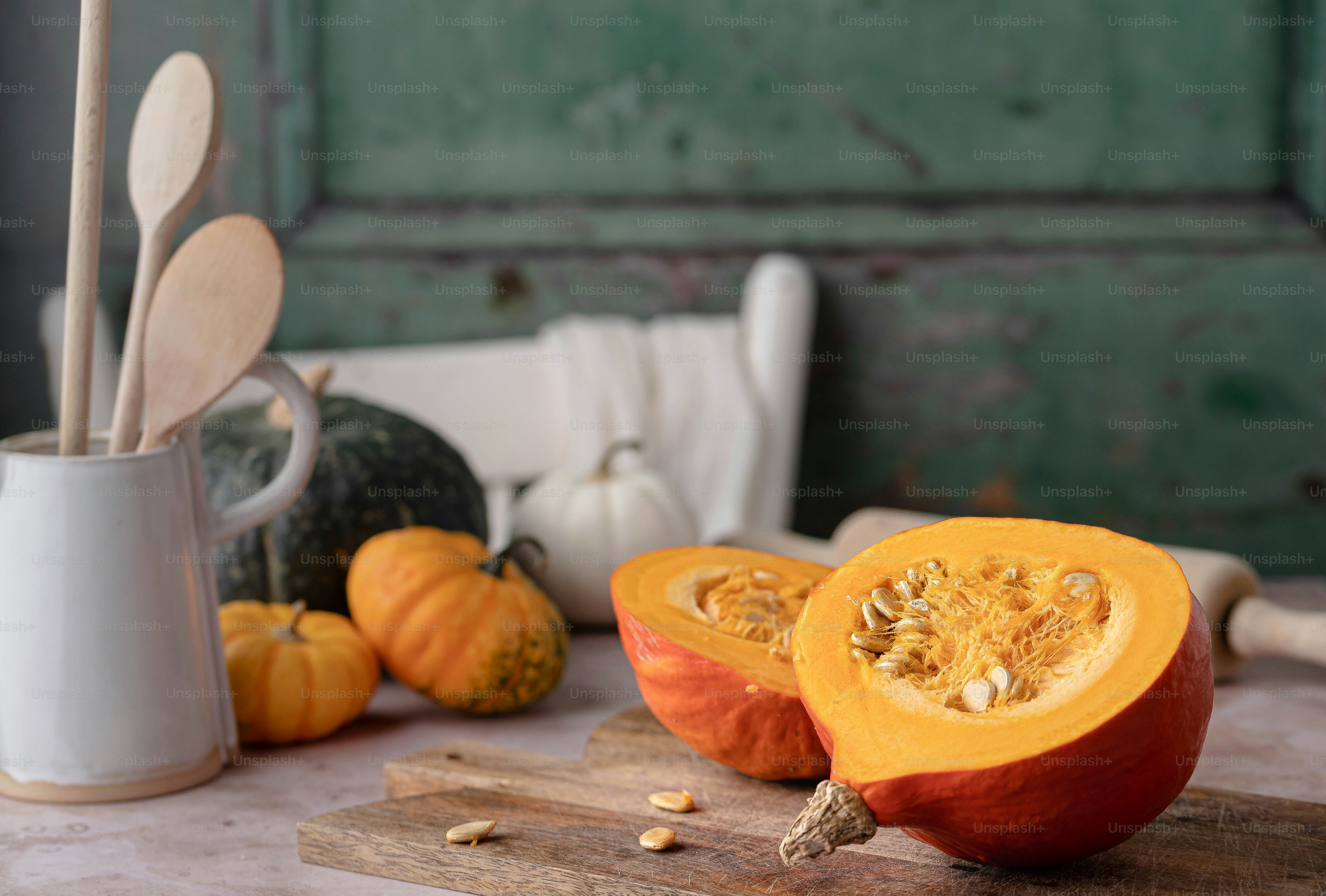 a couple of pumpkins sitting on top of a cutting board