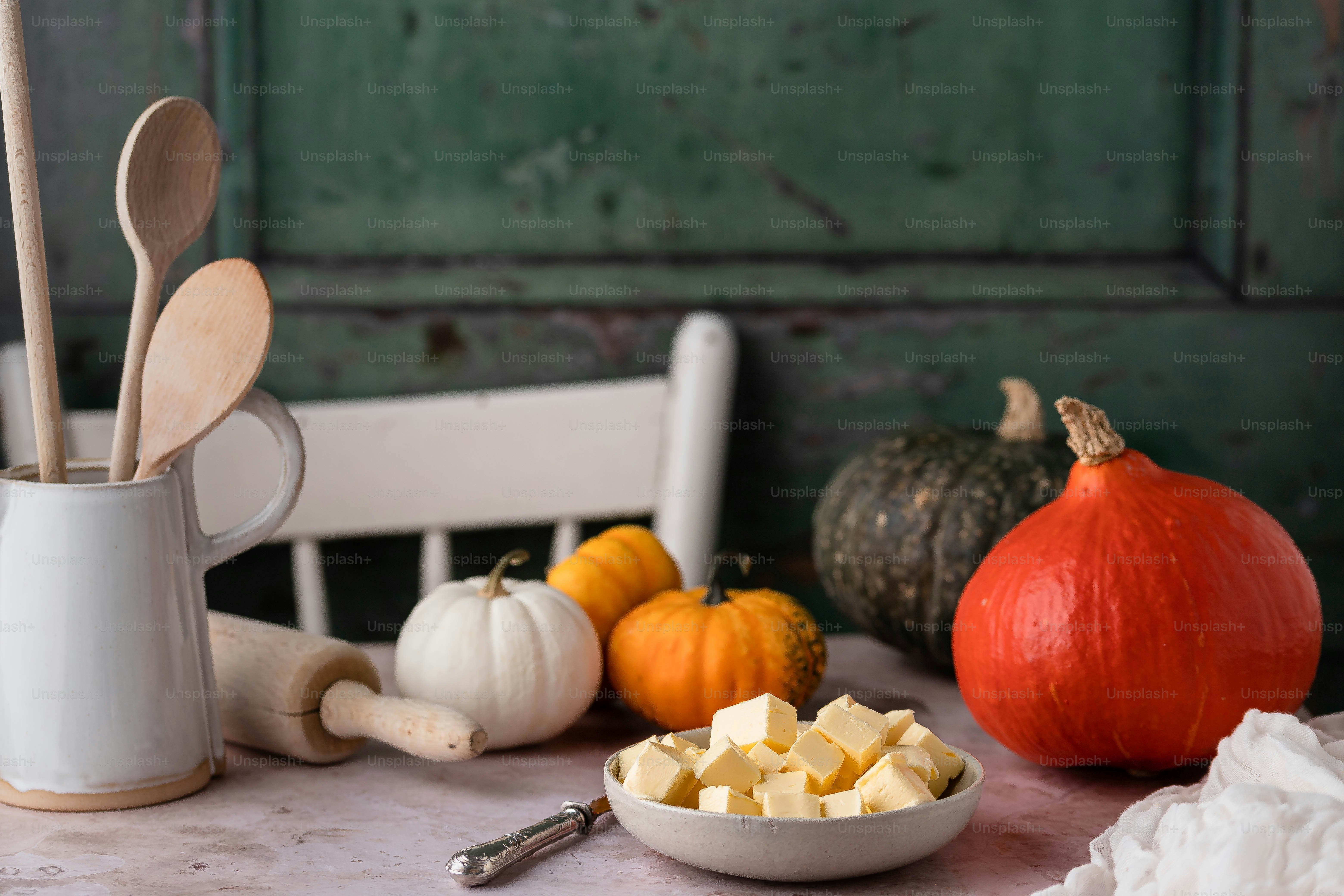a table topped with a bowl of food next to a wooden spoon