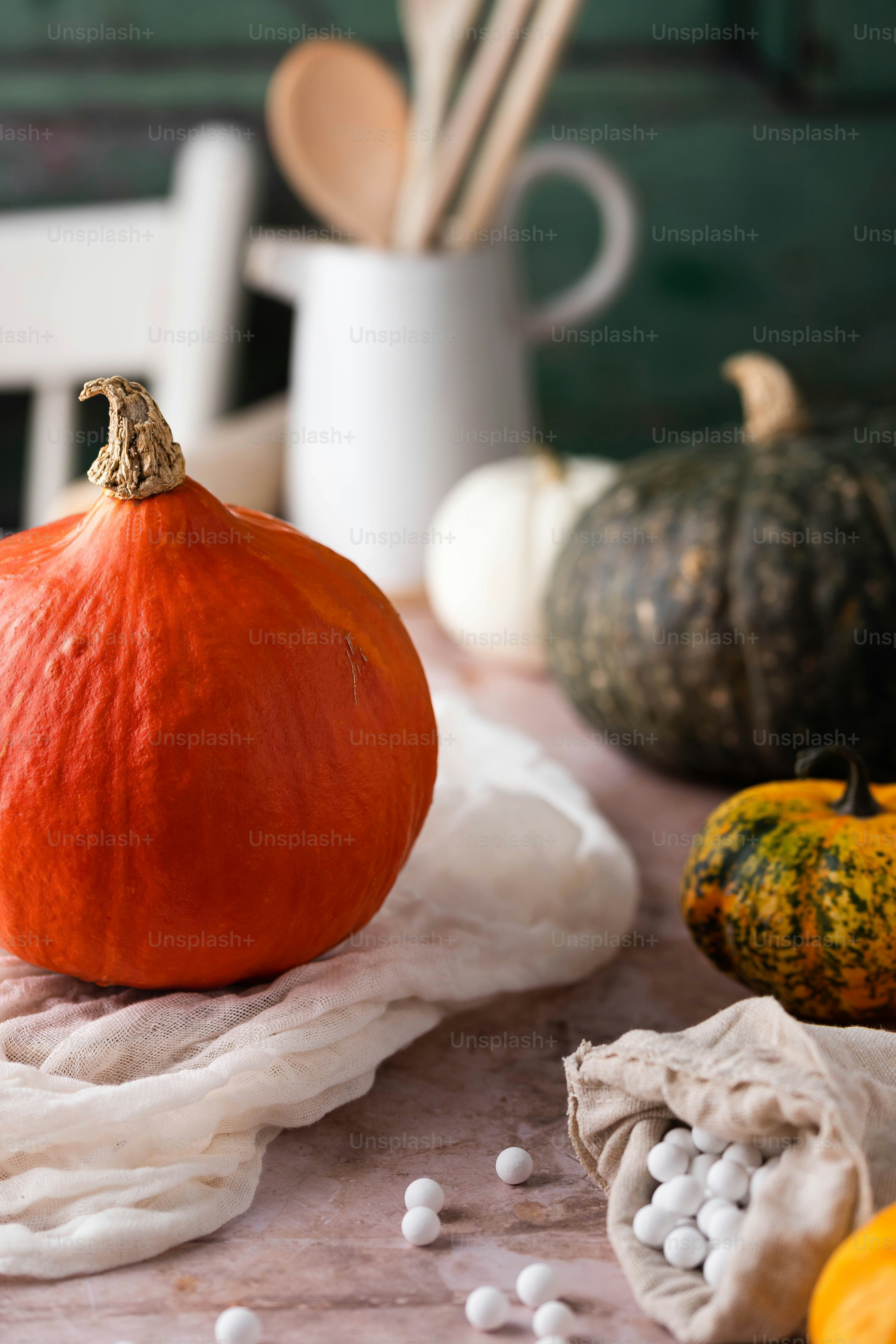 a pumpkin sitting on top of a table next to other pumpkins