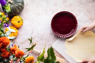 a person holding a spoon over a pie crust