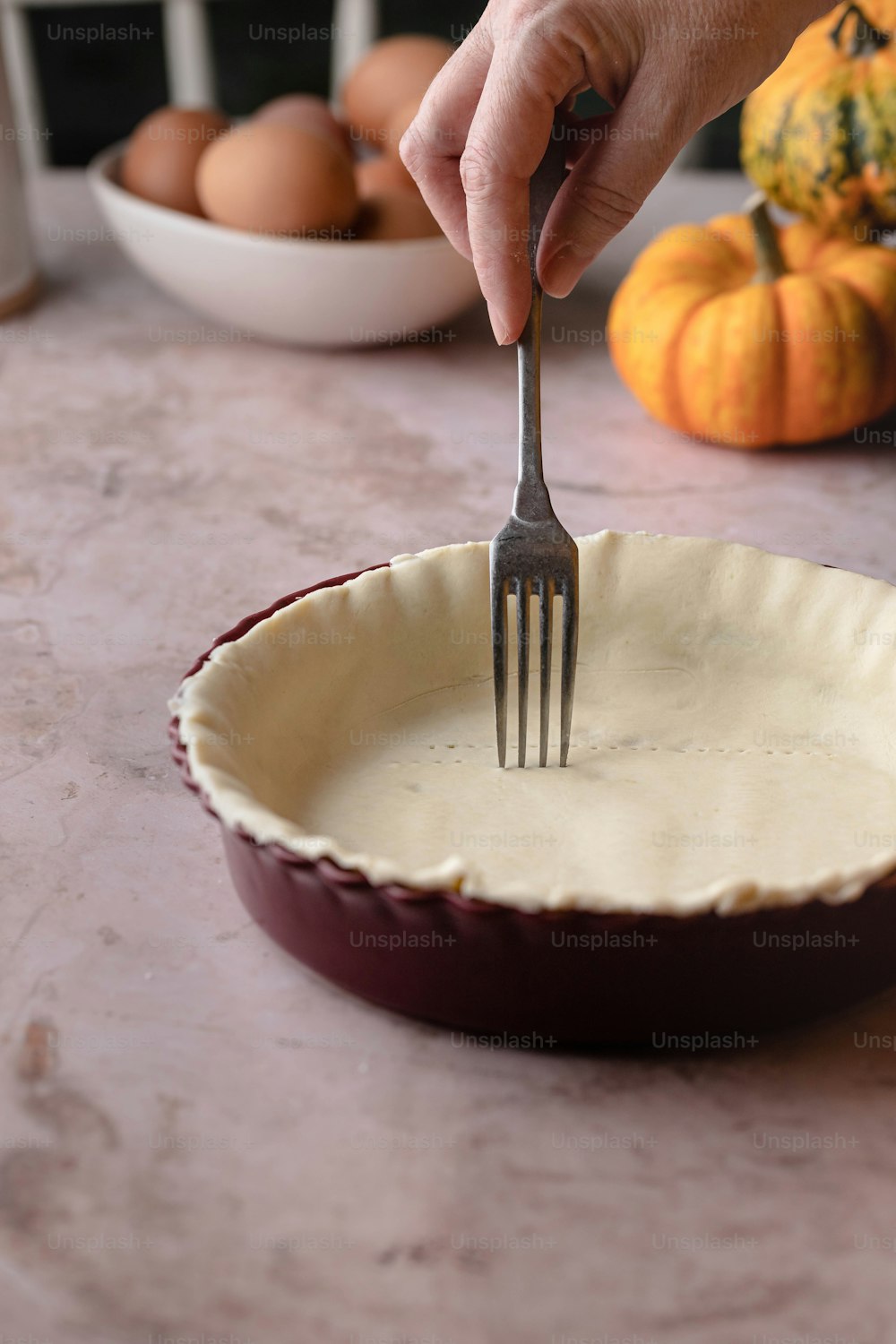 a person holding a fork in a pie pan