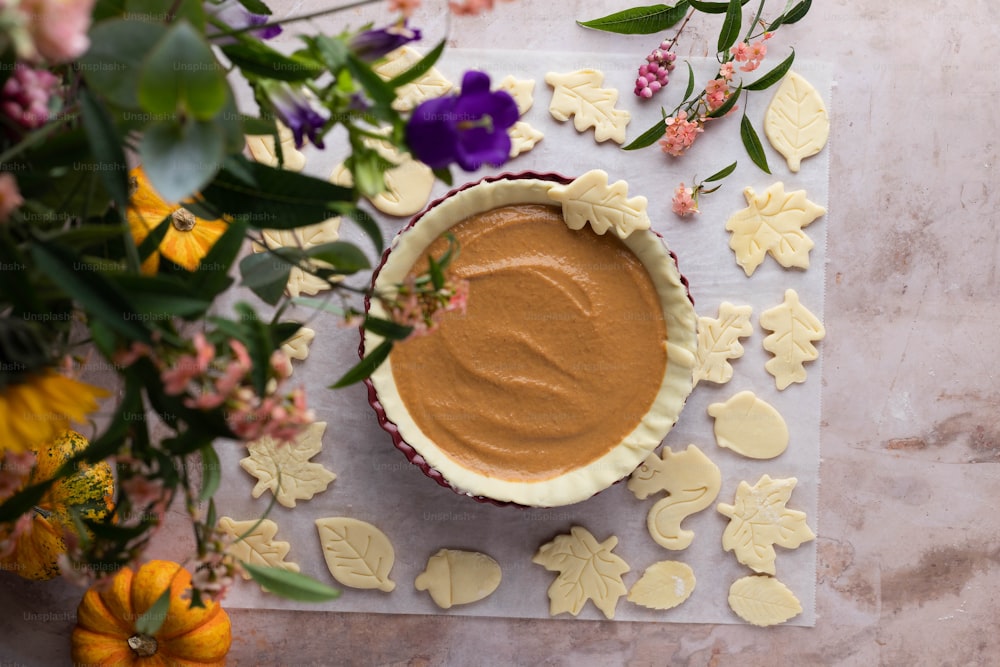 a bowl of peanut butter surrounded by flowers