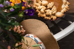 a close up of a pie and a hat on a table