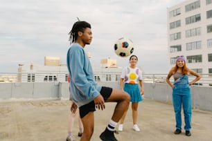 a group of young people playing with a soccer ball
