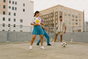 a couple of people that are playing with a ball