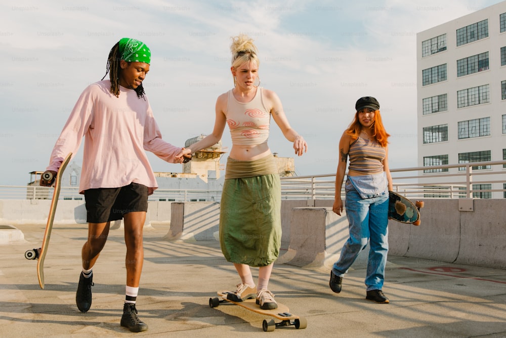 a group of young people riding skateboards down a sidewalk
