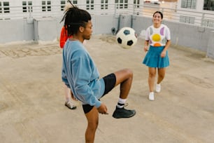 a man with dreadlocks kicking a soccer ball