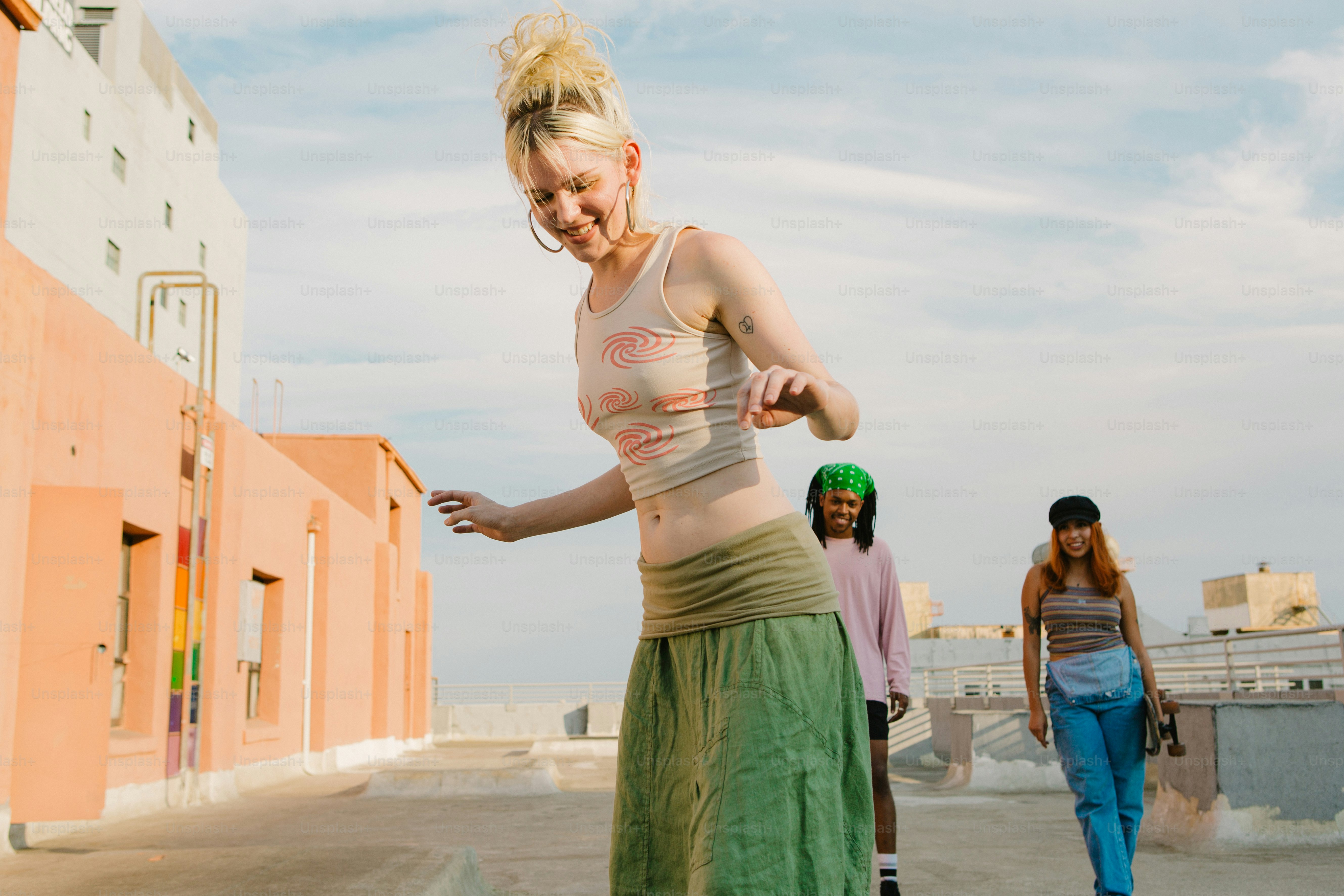 a woman riding a skateboard down a street