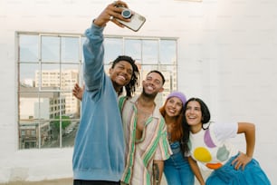 a group of friends taking a selfie with a cell phone
