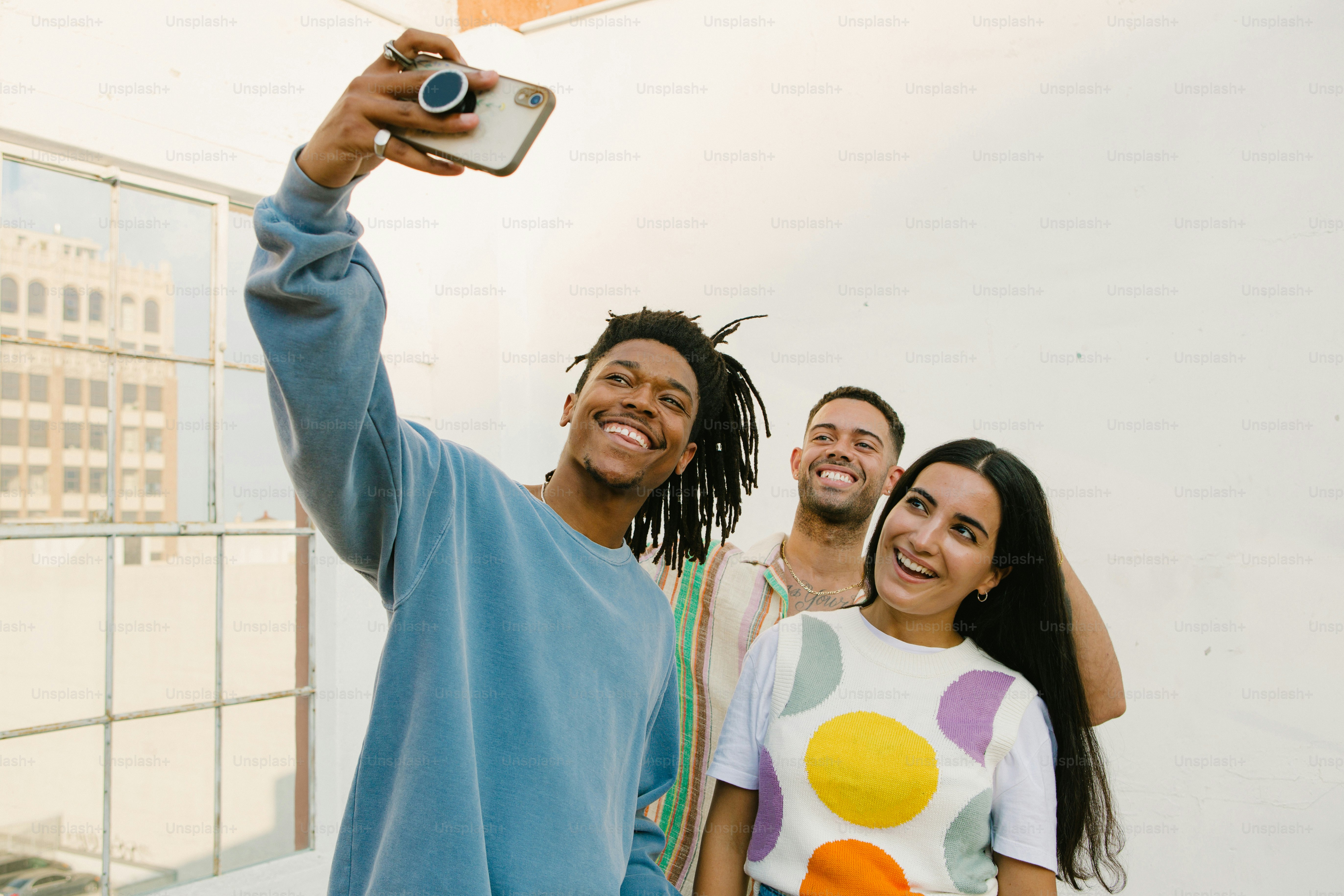 a man taking a selfie with two women