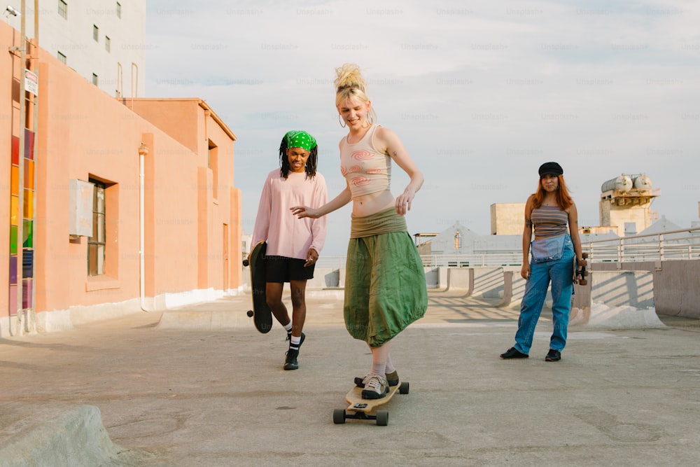 a woman riding a skateboard next to two other women
