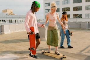 a man standing next to a woman on a skateboard