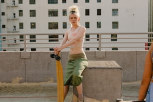 a woman holding a yellow bat next to a cement block