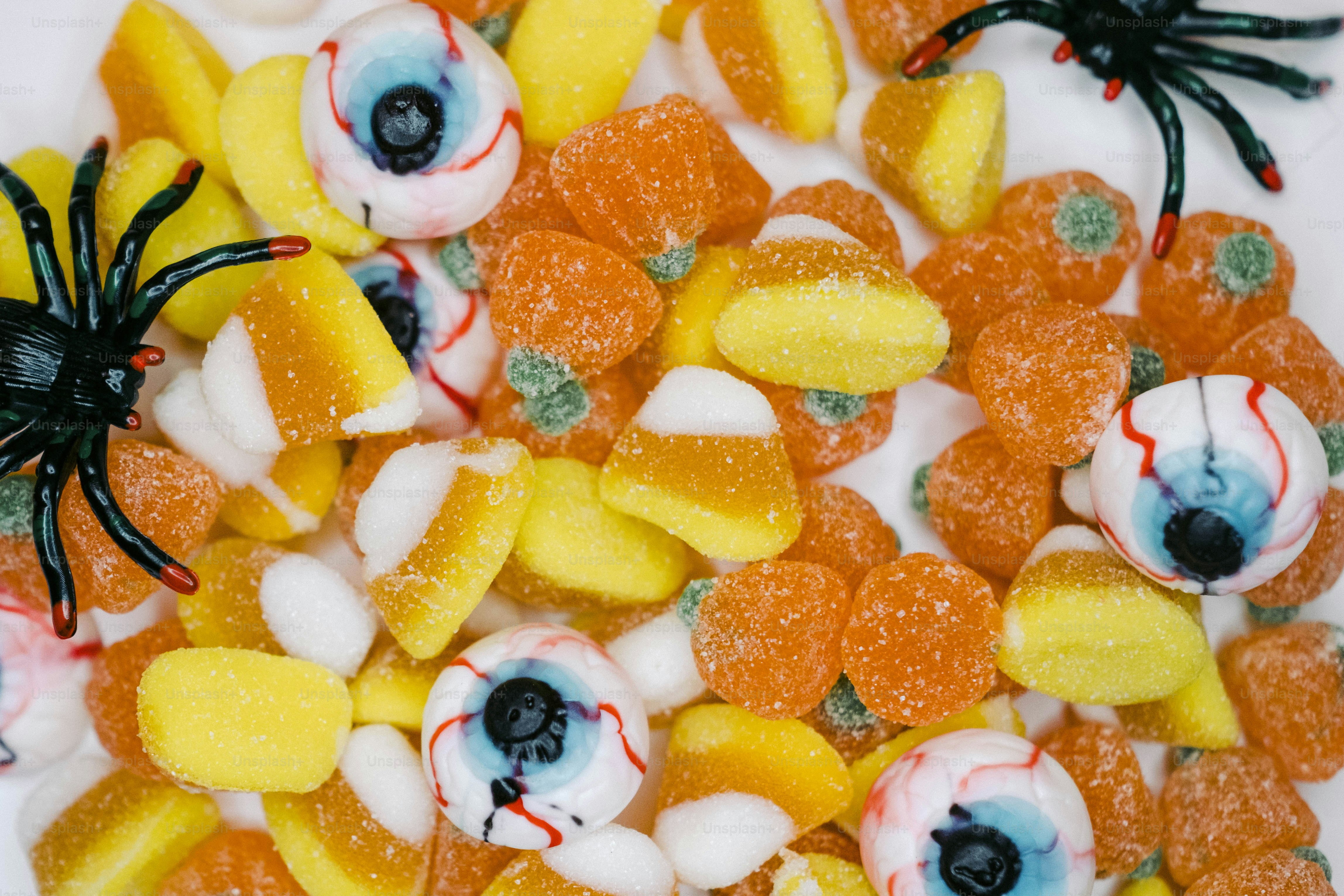 a close up of candy with eyes and candy candies